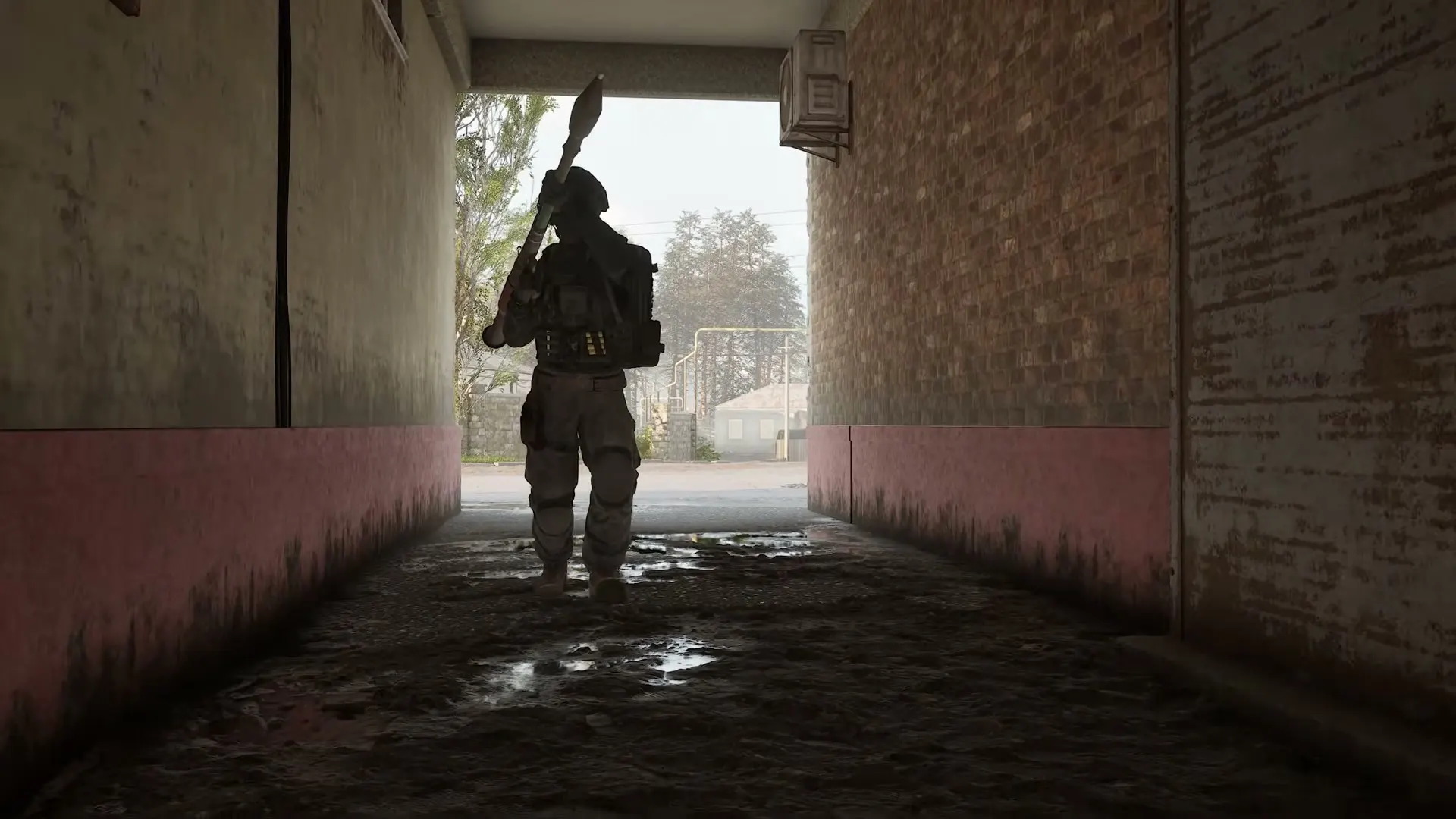 A lone WARDOGS operator silhouetted in a tunnel entrance