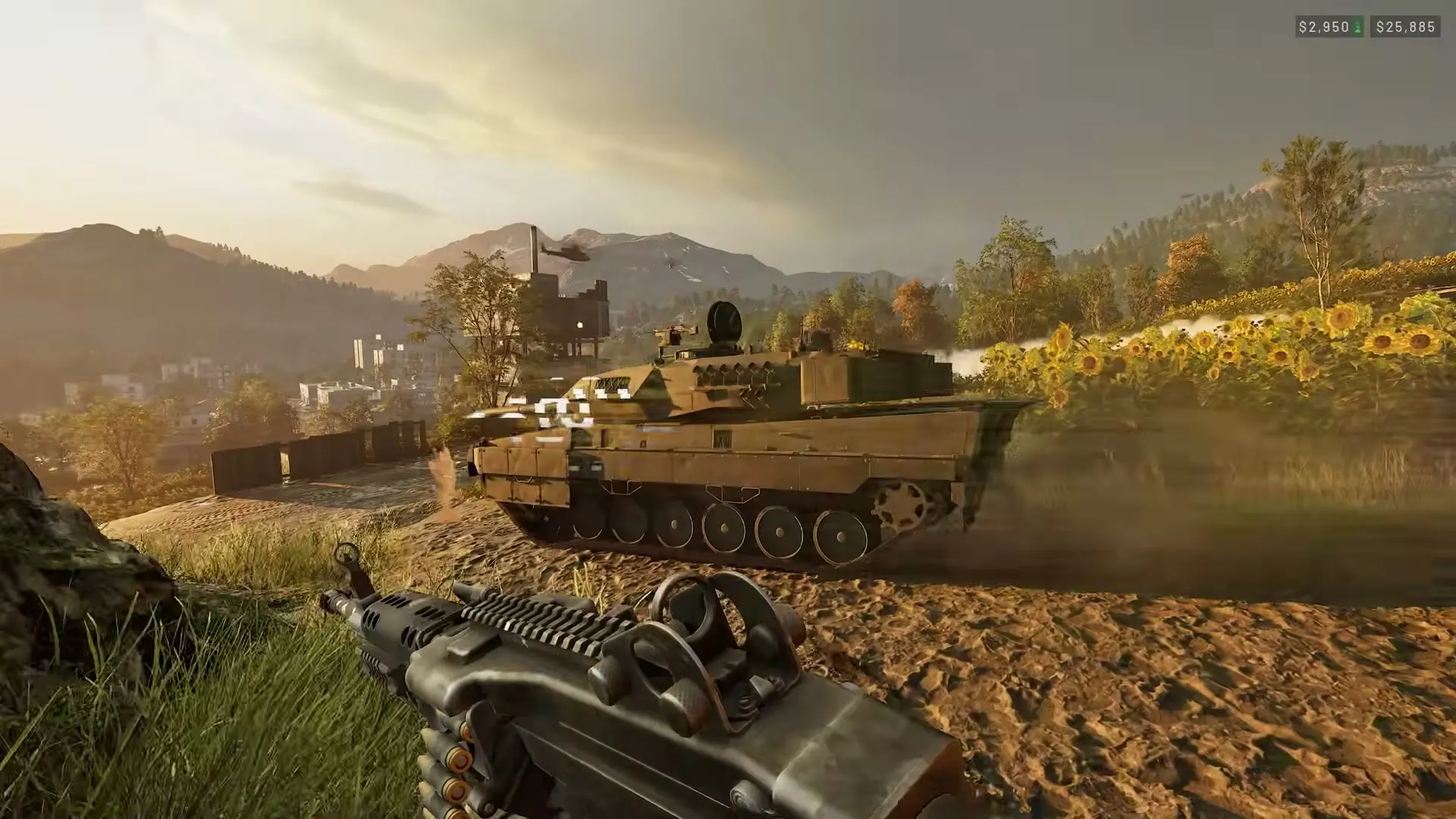 A WARDOGS infantry operator moving beside a tank in a field